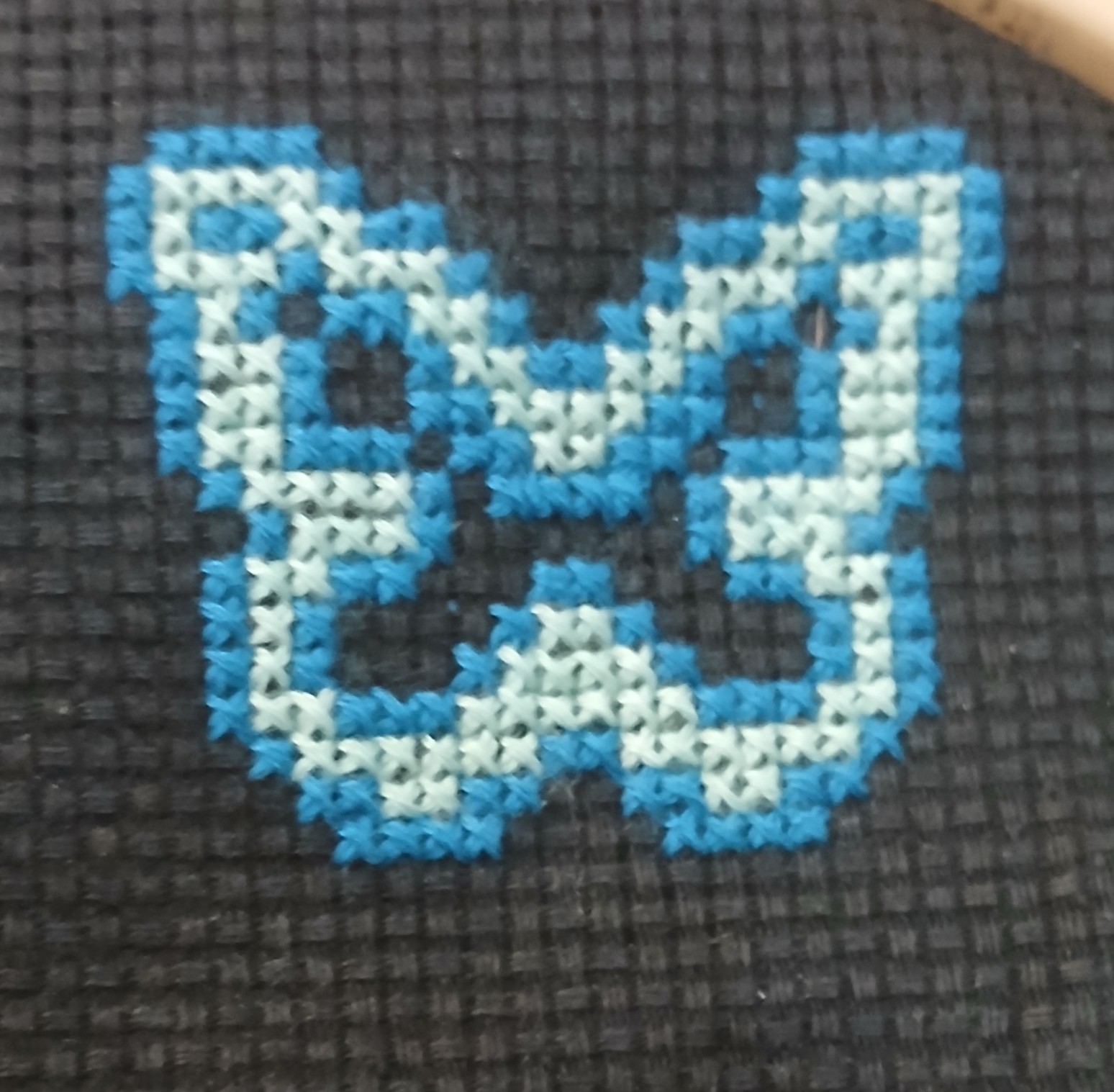 A cross stitch of a butterfly