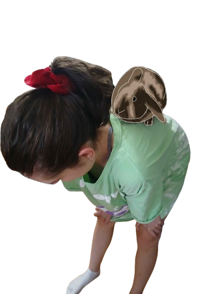 A rabbit sitting on my cousin, Rhiannon